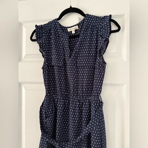 Manteau Los Angeles dress is a navy polka dot, v-neck sleeveless